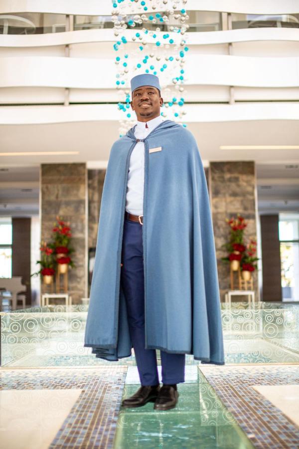 The View Bouznika Hotel Exterior photo A hotel manager wearing a blue cloak